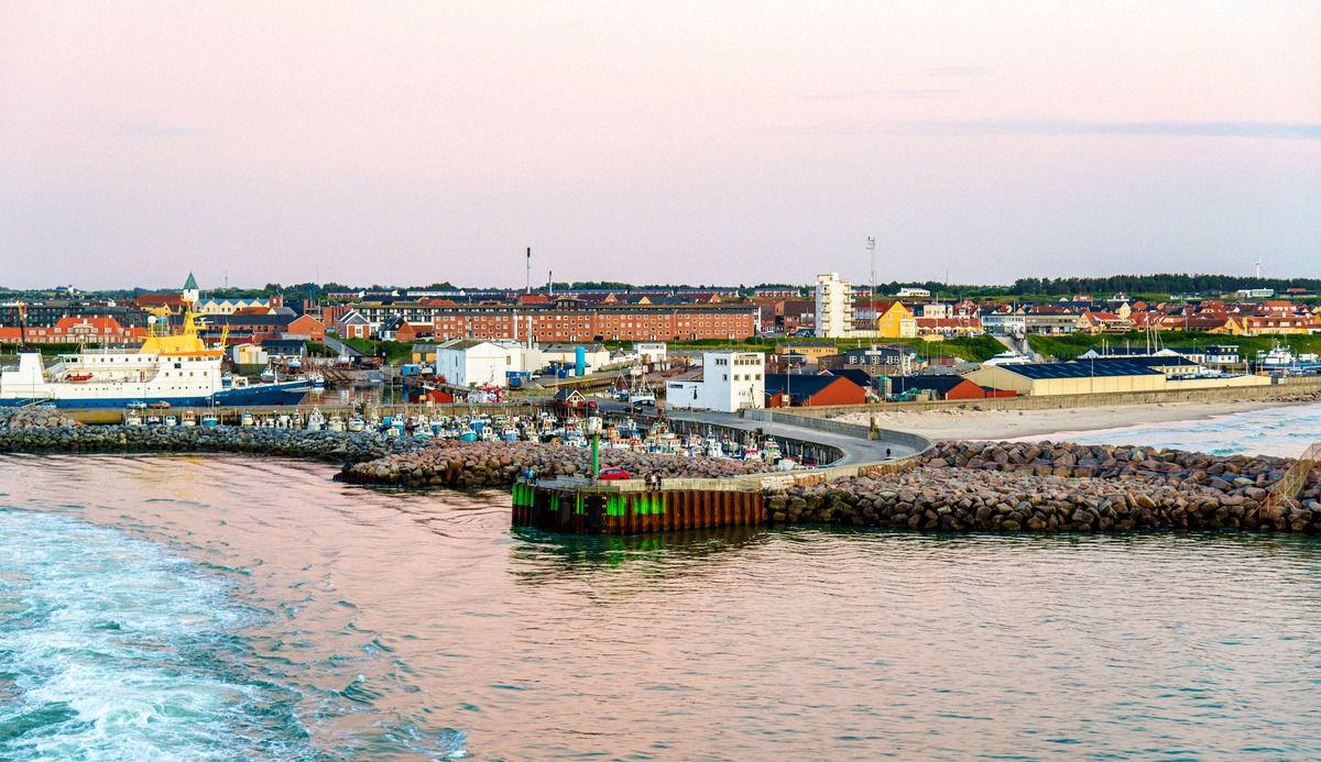 Hirtshals ferry port with breakwaters and beacon at dusk