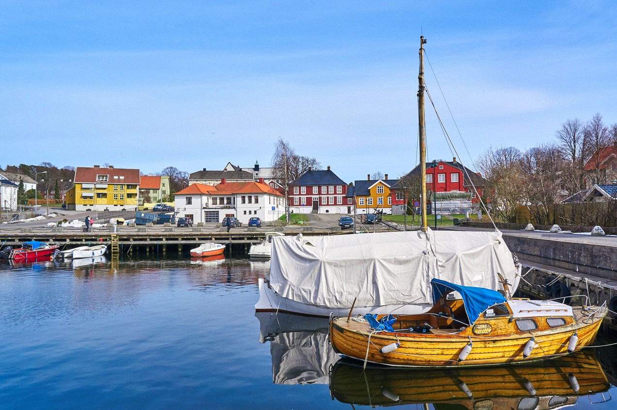 Larvik harbour with a wooden sailing boat by colourful quayside houses